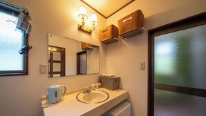 A bathroom with a sink, mirror, towel rack, and storage boxes. - Grand Hotel Narita Airport (Narita)
