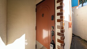 A brown door with a keypad lock and a small mailbox. - Grand Hotel Narita Airport (Narita)