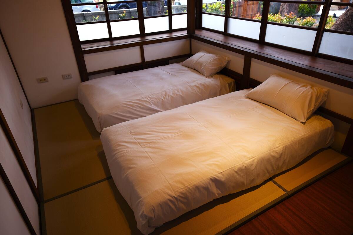 A traditional Japanese-style room with tatami flooring and sliding shoji doors.