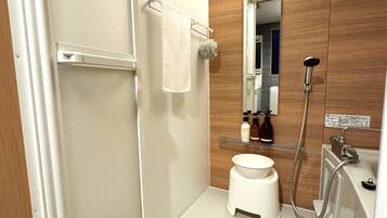 Combined shower/tub, designer toiletries, hair dryer, slippers