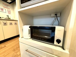 Hypo-allergenic bedding, desk, laptop workspace, blackout drapes