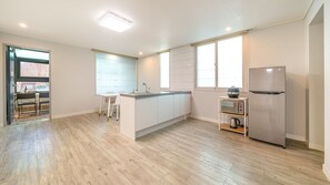 A modern kitchen with a central island, a built-in oven, and a microwave. - Gyeongju Gampo Laviangrose Pool Villa (Gyeongju)