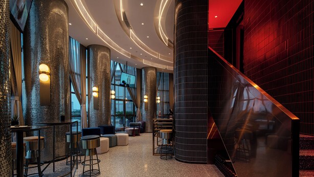 A modern lobby with a curved ceiling, seating areas, and a staircase. - Ethos Hotel Wuhan Riverside (Wuhan)