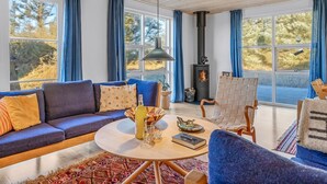 A cozy living room with a sofa, chairs, a coffee table, and a fireplace. - "Kaapo" - 300m from the sea by Interhome (Løkken)
