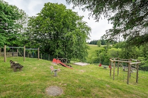 A playground with swings, slides, and climbing structures.
