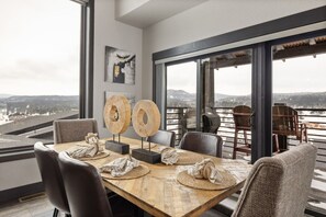 A dining area with a wooden table, chairs, and two wooden decorative items.