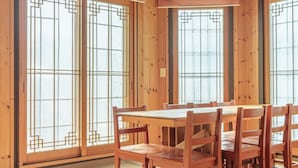 A traditional Japanese-style room with tatami mat flooring, a wooden table, and sliding doors with geometric patterns. - Gapyeong Sanneomeo Private Pension (Gapyeong)