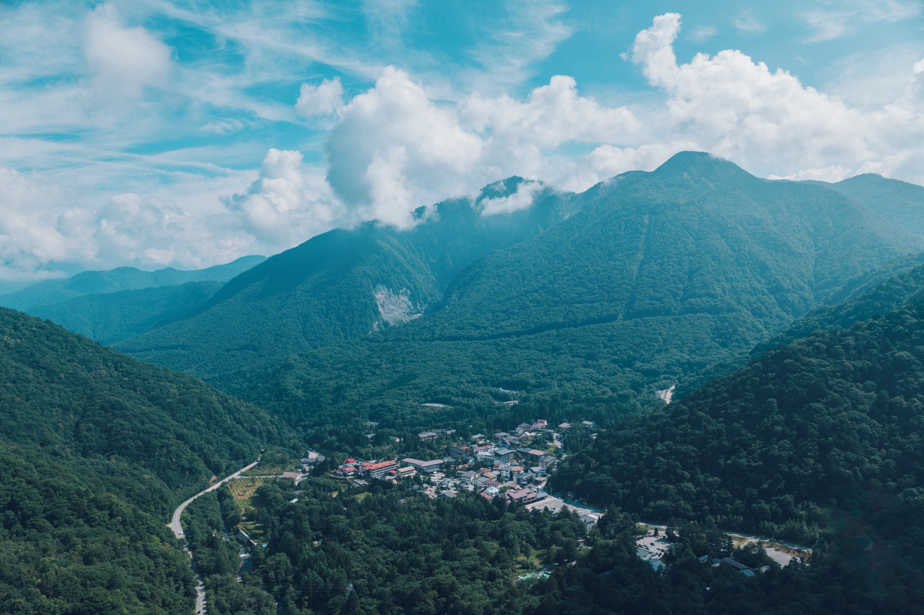 A mountainous landscape with a small town nestled in a valley.