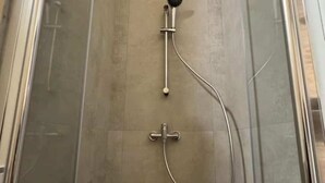 A shower with a handheld showerhead and a handheld scrubber. - Suite 2 (Ravenna)
