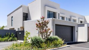 A modern two-story building with a flat roof, large windows, and a garage. - Townhouse on Tod Glenelg North (Glenelg North)