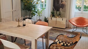 A dining area with a wooden table, chairs, and a potted plant. - A Magnagnerie in Provence (Bouchet)