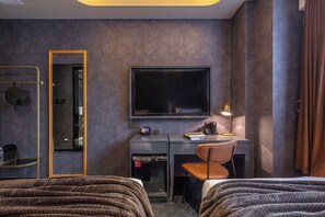 A hotel room with a bed, a desk with a chair, a television, a mirror, and a wardrobe. - A forest s hotel (Shanghai)