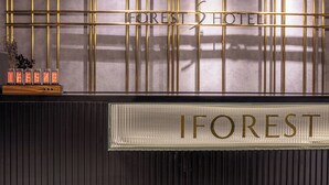 A hotel sign with the name "FOREST HOTEL" and a decorative display of lights. - A forest s hotel (Shanghai)