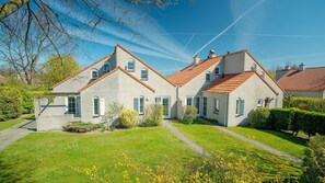 A two-story house with a brick exterior and a red-tiled roof. - Summio Parc Port Greve (Brouwershaven)