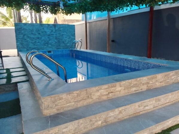 Relax by the pool surrounded by lush surroundings and enjoy a refreshing swim.
