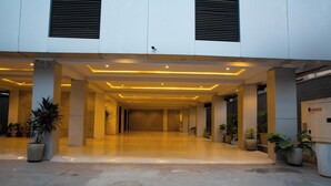 A spacious indoor area with a polished floor, large pillars, and potted plants. - Mr Bay Hotel (Lagos)
