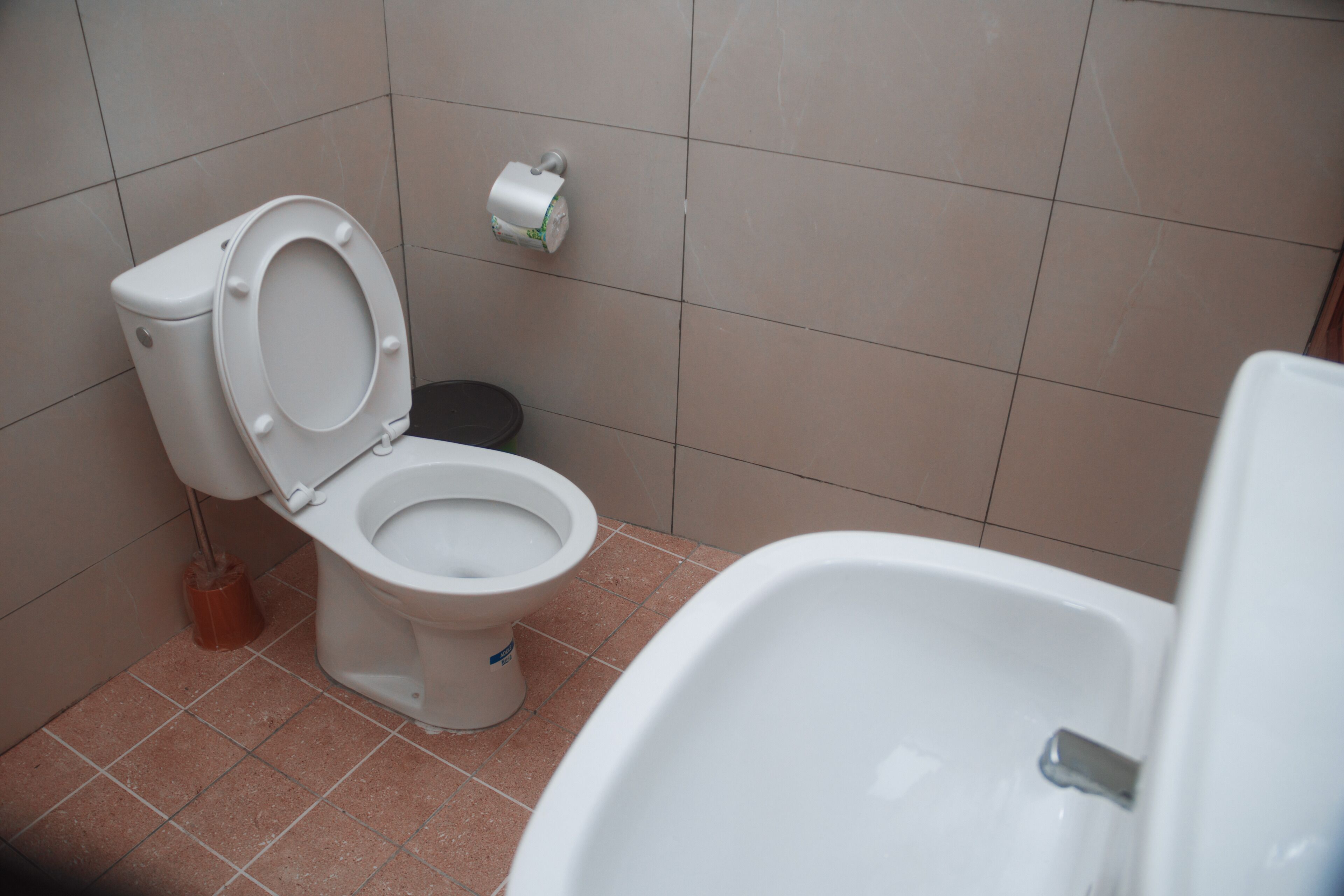 A bathroom with a toilet, bidet, and sink.