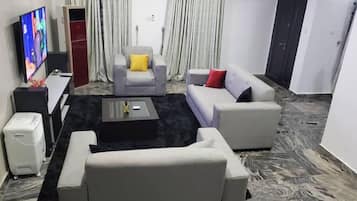 Economy Apartment, Balcony, City View | Living area | Flat-screen TV