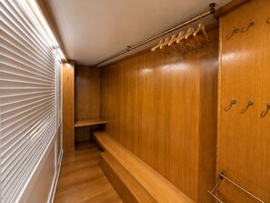 A wooden closet with a bench, a coat rack, and a hanging rod. - Penthouse with Terrace near Pantheon (Roma)