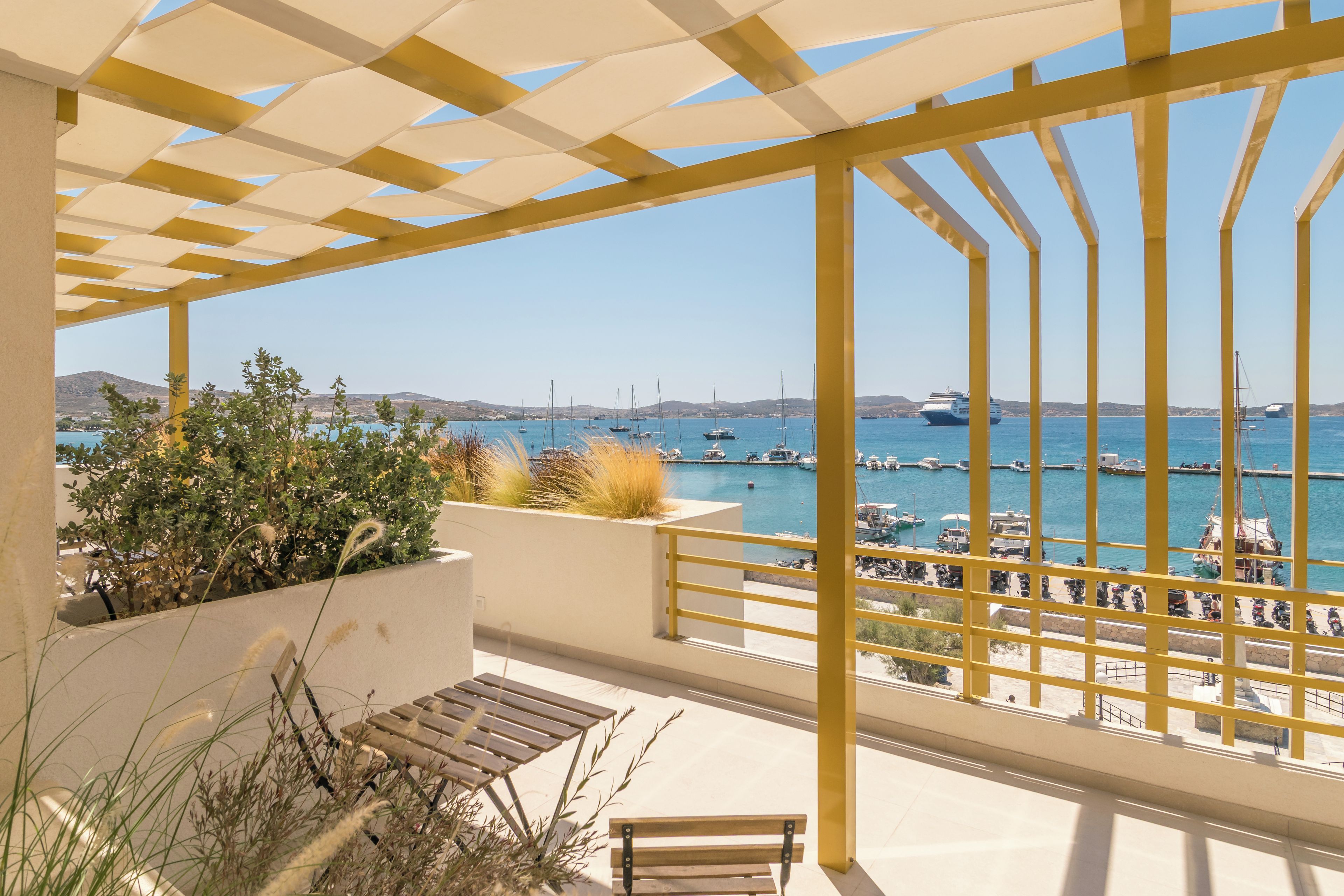 A balcony with a view of a marina and boats.