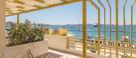 A balcony with a view of a marina and boats.