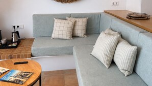 A modern living room with a light grey sectional sofa, a round woven wall decoration, and two tall woven pendant lights. - Apartment with terrace and sea view - 3 bedrooms - Llançà (Cap de Creus) (Llançà)