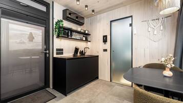 Mini-fridge, stovetop, electric kettle, cookware/dishes/utensils