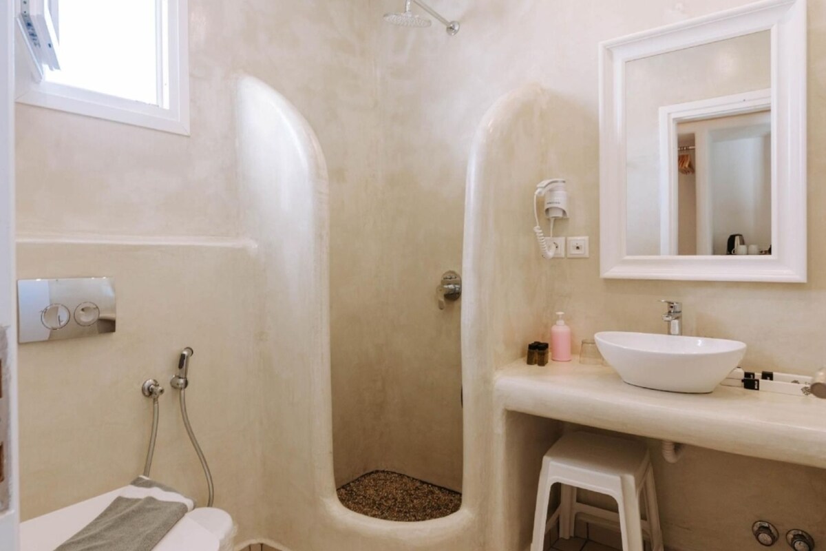 A bathroom with a bathtub, a sink, a mirror, and a shower.