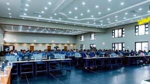 A large conference room with rows of tables and chairs, equipped with laptops and water bottles. - Platinum Lodge (Matola)