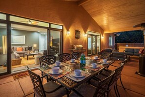 A dining area with a table set for six, surrounded by chairs, with a view of the interior living space. - 5 Bed, 3 Bath Uptown Sedona-Game Room-Sauna-Cold Plunge-Jacuzzi-Gym (Sedona)