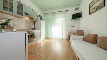 Family Apartment, Multiple Bedrooms (Oasis Of Peace In Lopar) | Living area | 21-inch flat-screen TV with satellite channels