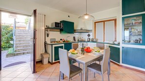 A compact kitchen with a dining area, a microwave, and a sink. - Lakeview Bliss / Pool & Fenced Garden (Villanuova sul Clisi)