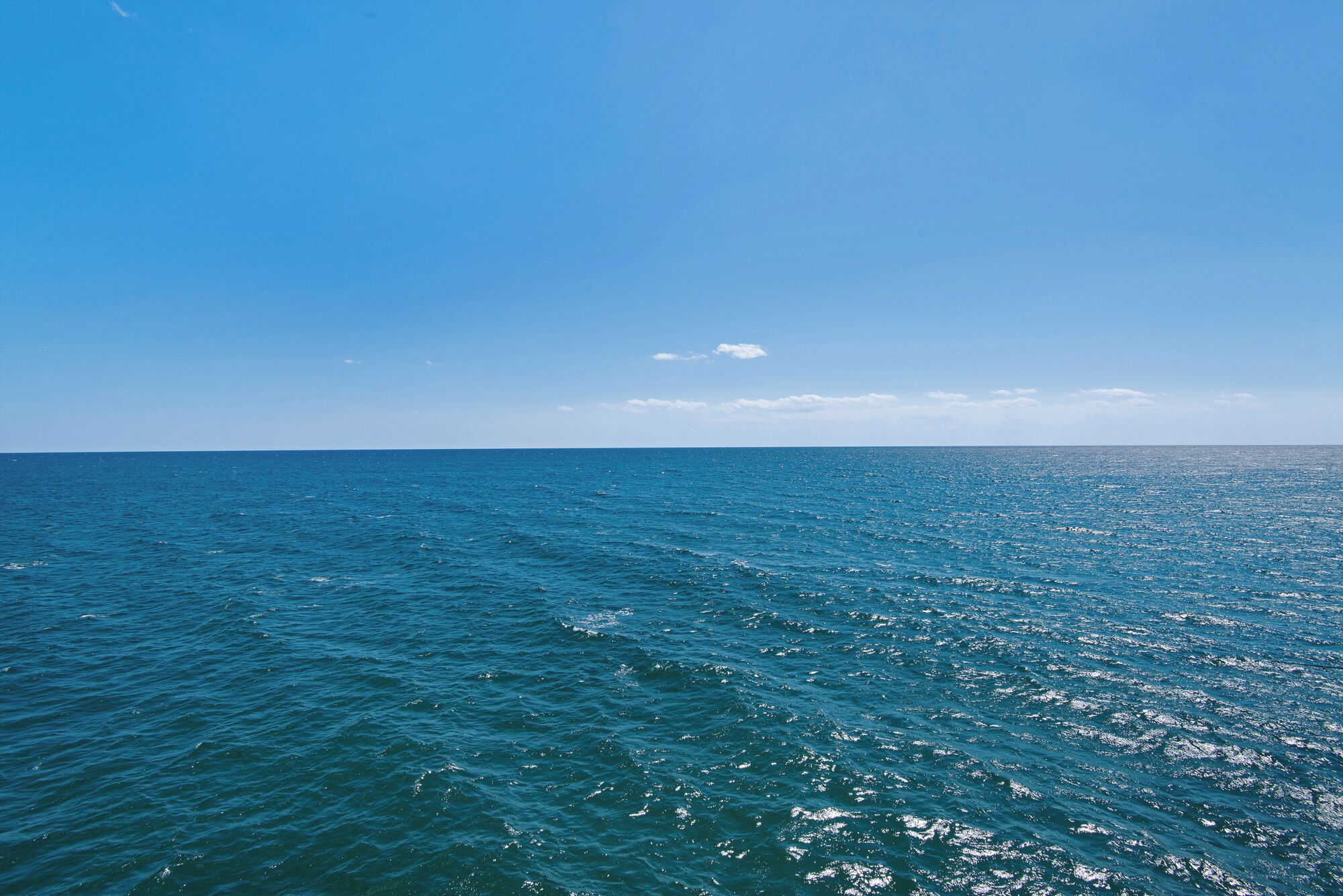 A view of the ocean with a clear sky.