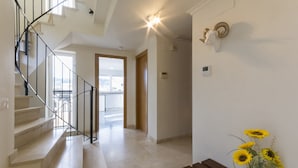 A staircase with a glass railing leading to an open area with a view. - Coll Groc in Grau i Platja (Gandia)