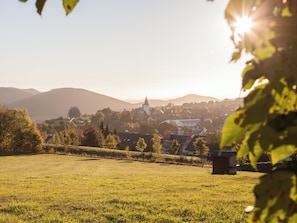 A rural landscape with a church and residential buildings, surrounded by fields and hills. - Am S Dhang 27 Winterberg Cozy Holiday Home Near Center ski Area (Winterberg)