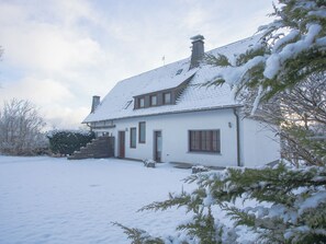 A two-story house with a snow-covered roof and a front porch. - Am S Dhang 27 Winterberg Cozy Holiday Home Near Center ski Area (Winterberg)