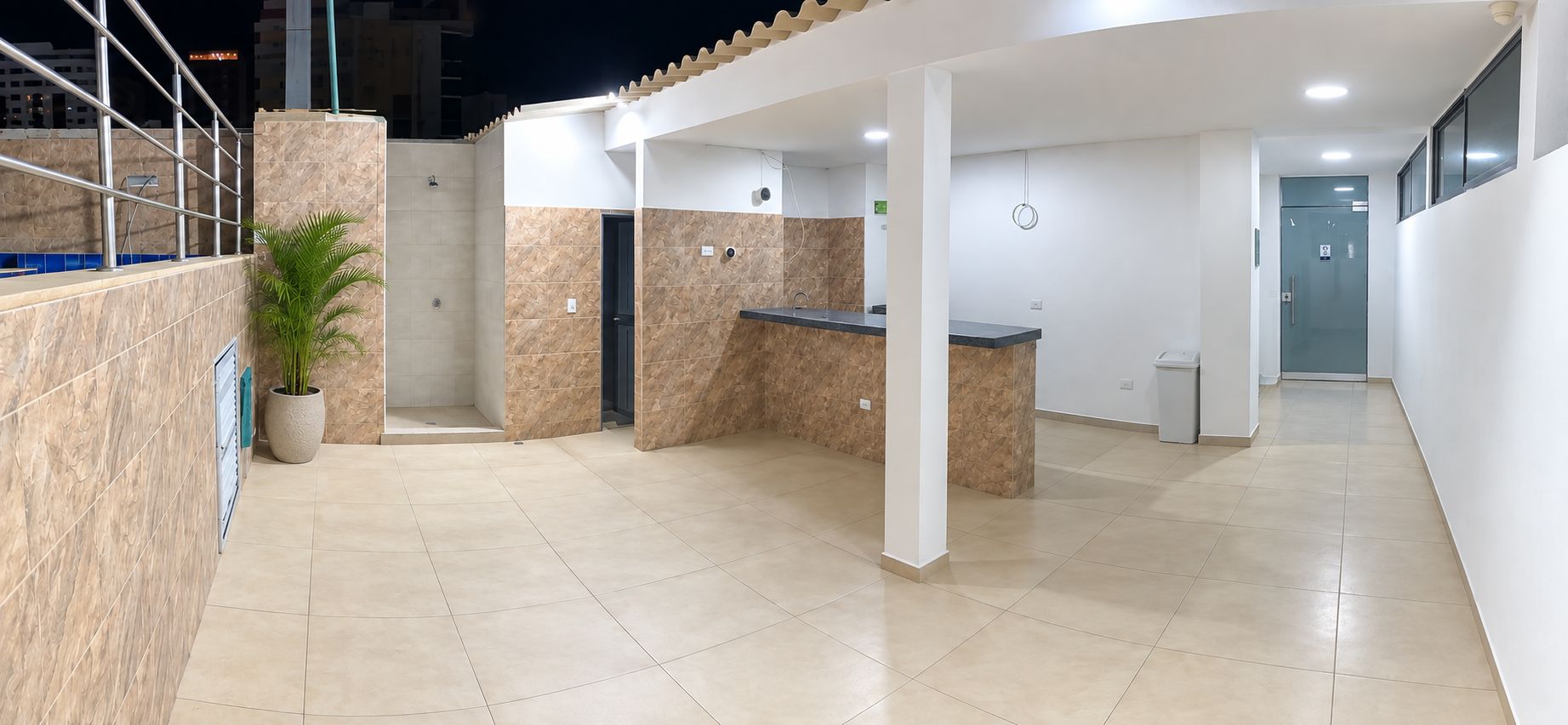 A clean, modern reception area with a reception desk, a small seating area, and a potted plant.