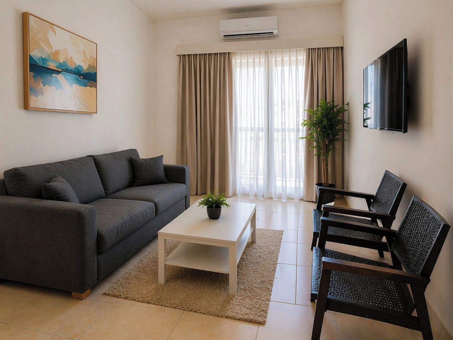 A living room with a sofa, a coffee table, a TV, and a plant.