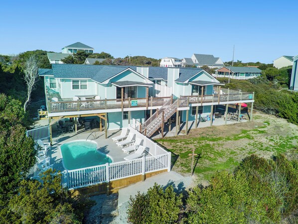 A multi-story beachfront property with a swimming pool, multiple decks, and a covered patio area. - Spectacular views from this 2nd Row East side Duplex - New for 2025 Shared Pool (Emerald Isle)