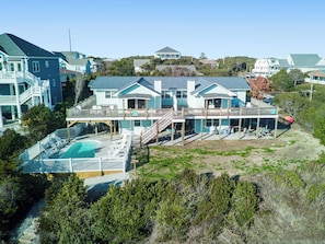 A large, multi-story beachfront property with a swimming pool, multiple decks, and a covered outdoor area. - Spectacular views from this 2nd Row East side Duplex - New for 2025 Shared Pool (Emerald Isle)