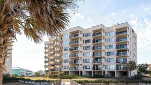 A multi-story residential building with balconies and large windows. - Sound of the Sea West 115 - Almost Oceanfront 2 BR 2 BA Condo (Emerald Isle)