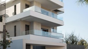 A modern multi-story building with balconies, large windows, and a flat roof. - Glyfada Experience Residence (Glyfada)