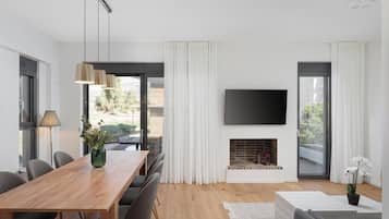 Apartment, City View | Living area | 50-inch Smart TV with satellite channels, fireplace, Netflix