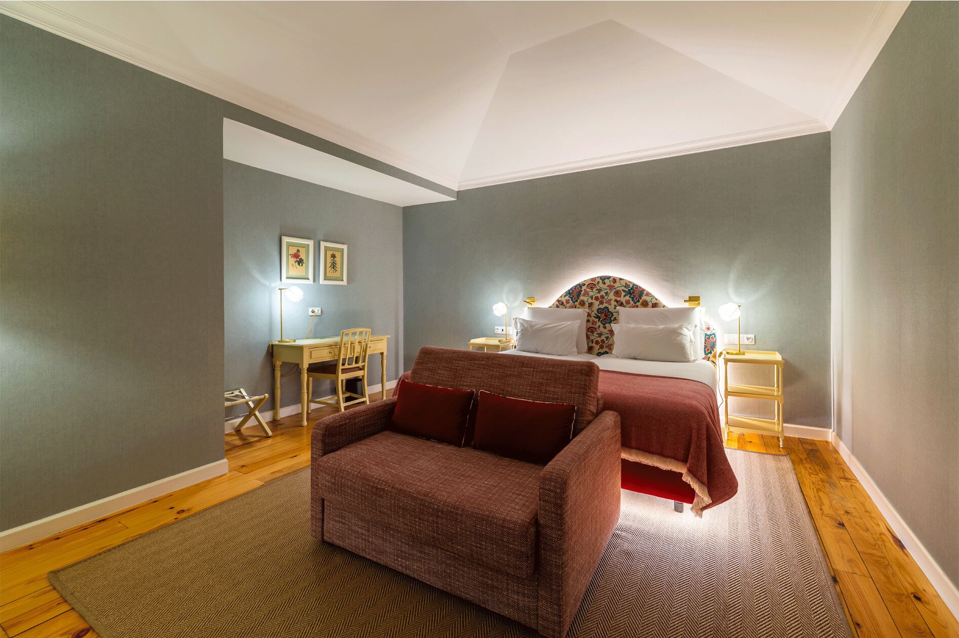 A bedroom with a bed, a desk, and a chair.