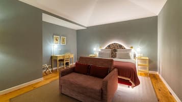 A bedroom with a bed, a desk, and a chair.