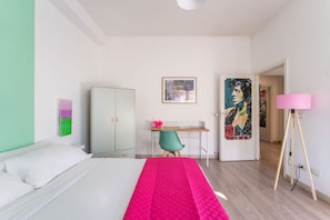 A hotel room with a bed, desk, chair, wardrobe, and artwork on the walls. - HOUSE OF MUSIC in Pigneto, METRO C to Colosseo (Roma)