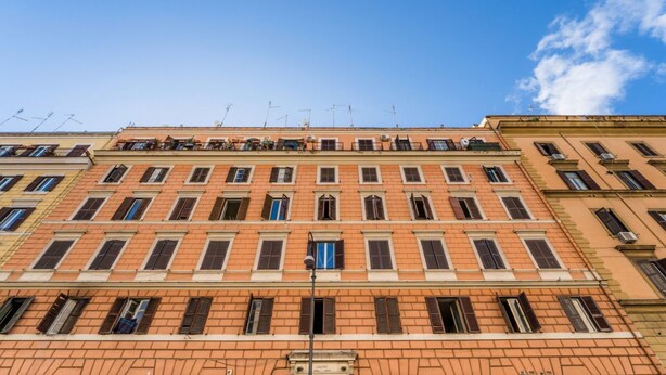 A multi-story building with a consistent architectural style, featuring evenly spaced windows and a central entrance. - Casetta Giolitti, Cozy Apartment in the Heart of Rome (Roma)