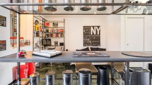 A modern kitchen with a countertop, a coffee machine, and a bookshelf. - Comics Roma Penthouse, Funny Flat Nearby Colosseum (Roma)