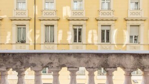 A yellow building with multiple windows and balconies, featuring classical architectural details. - Home of Arts, Concept apt in the Center of Rome (Roma)