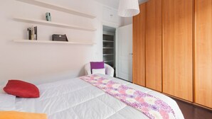 A bedroom with a bed, a wardrobe, a closet, and a hanging light fixture. - The Vatican Rest, Elegant Apt Nerby the Basilica (Roma)